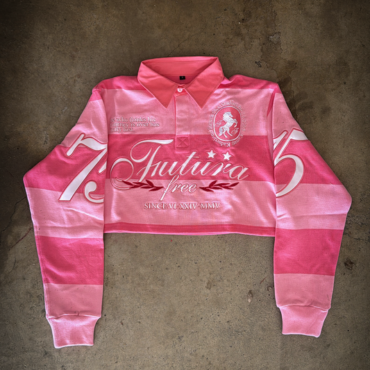 Pink long-sleeve polo shirt with branding on a concrete floor